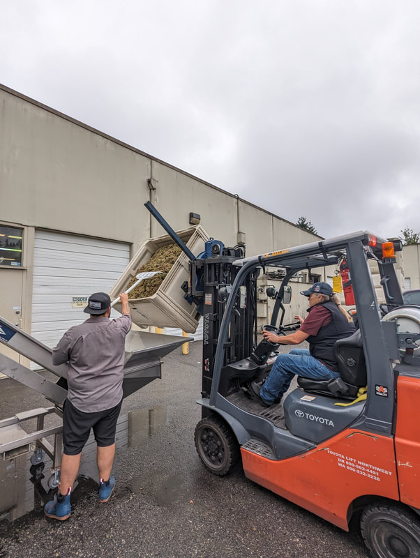 man moving grapes woman on forklift